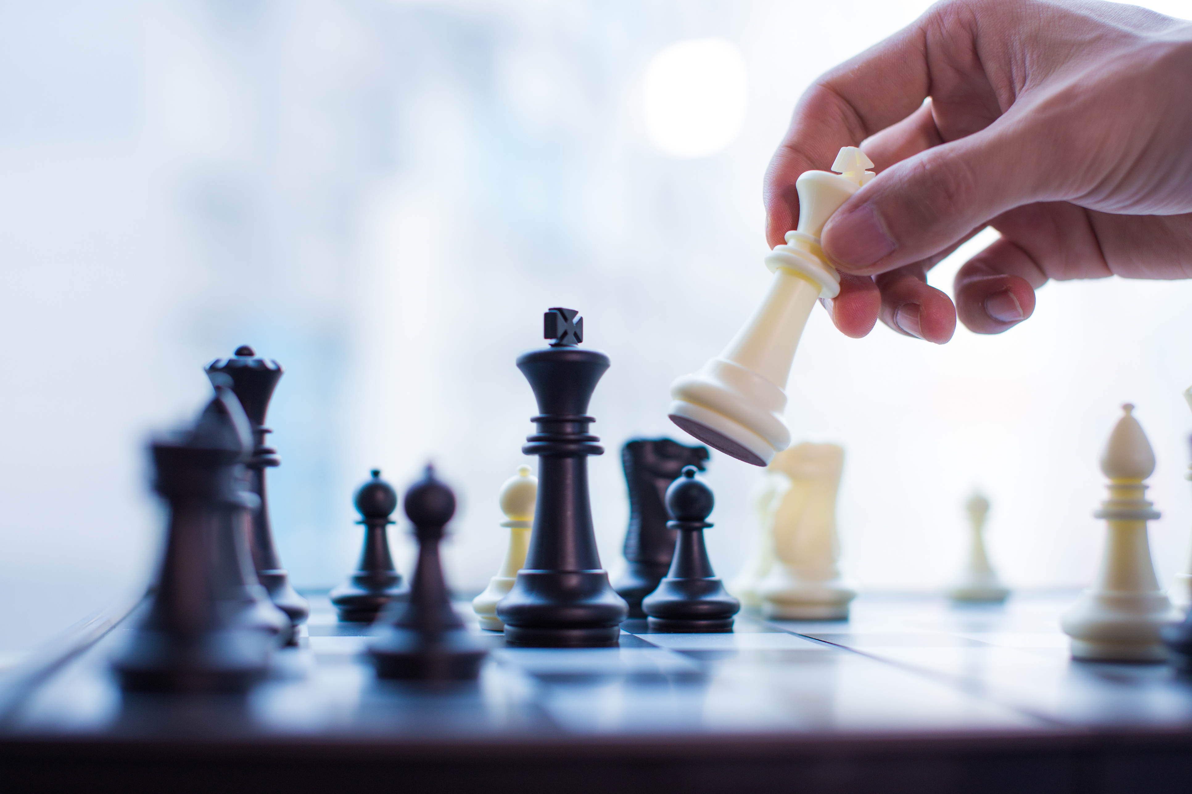 Hand moving the king in chess game